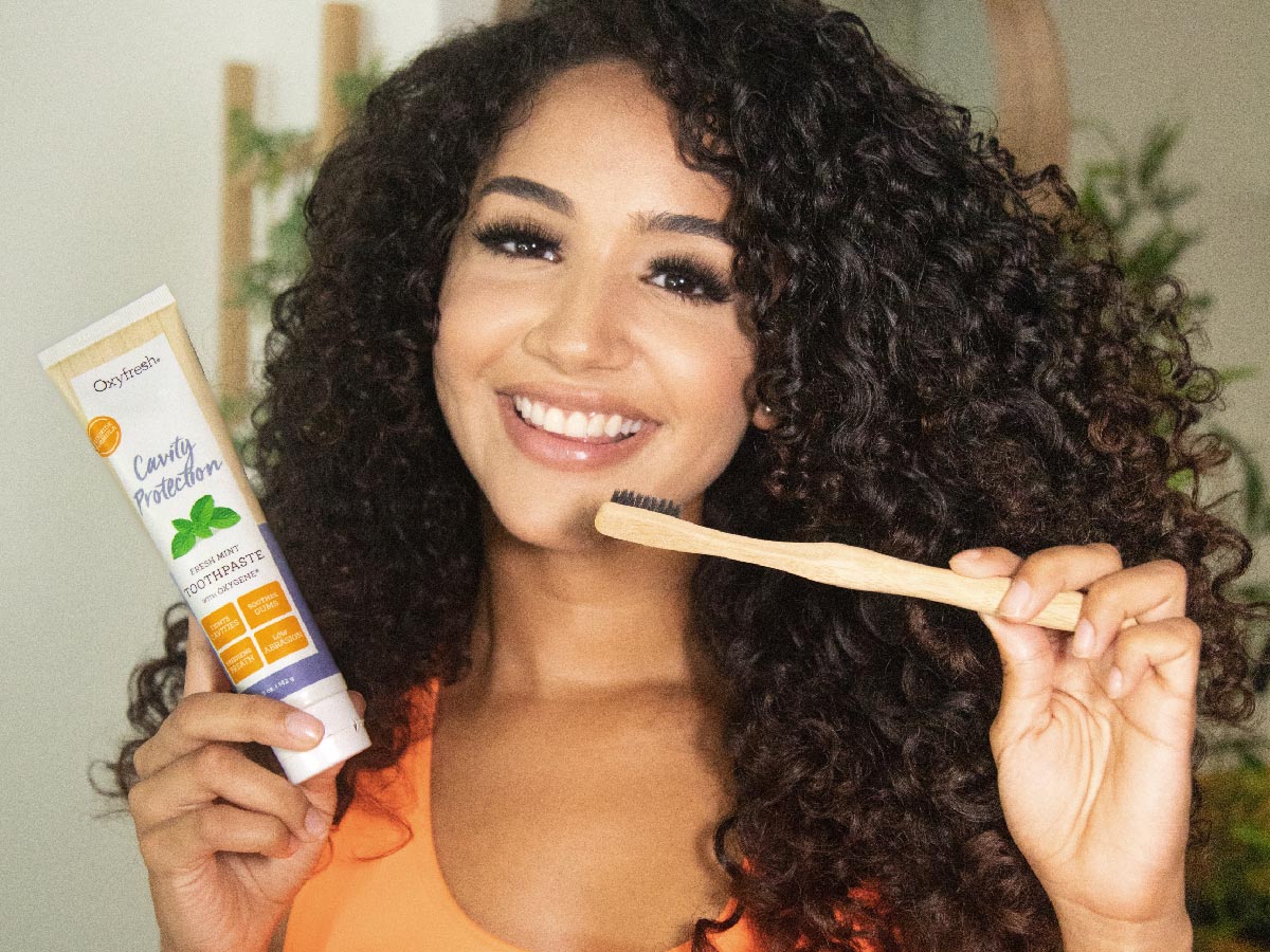 oxyfresh-cavity-protection-toothpaste_smiling-woman-holding-oxyfresh-cavity-protection-toothpaste