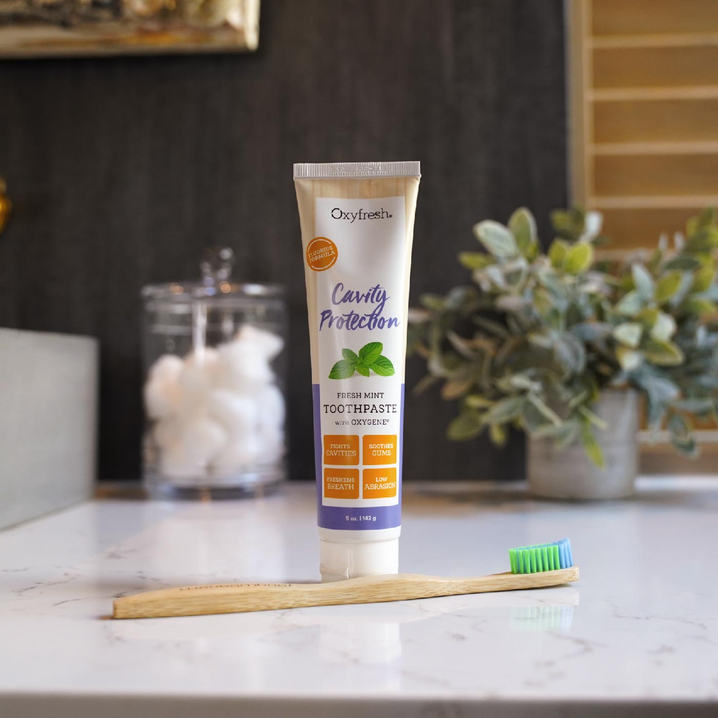 oxyfresh-cavity-toothpaste-sitting-on-counter-being-toothbrush