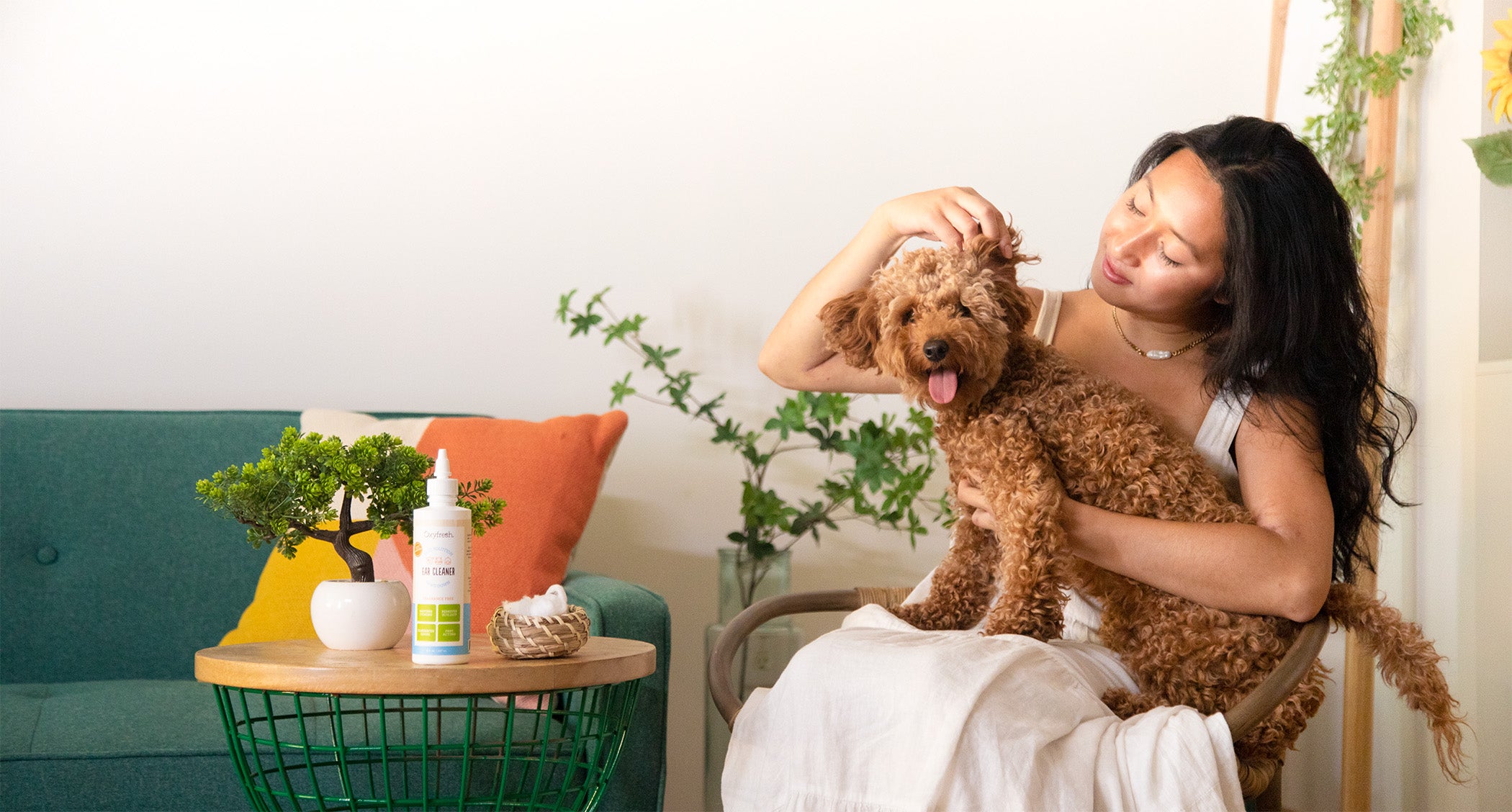 woman inspecting her dogs ears