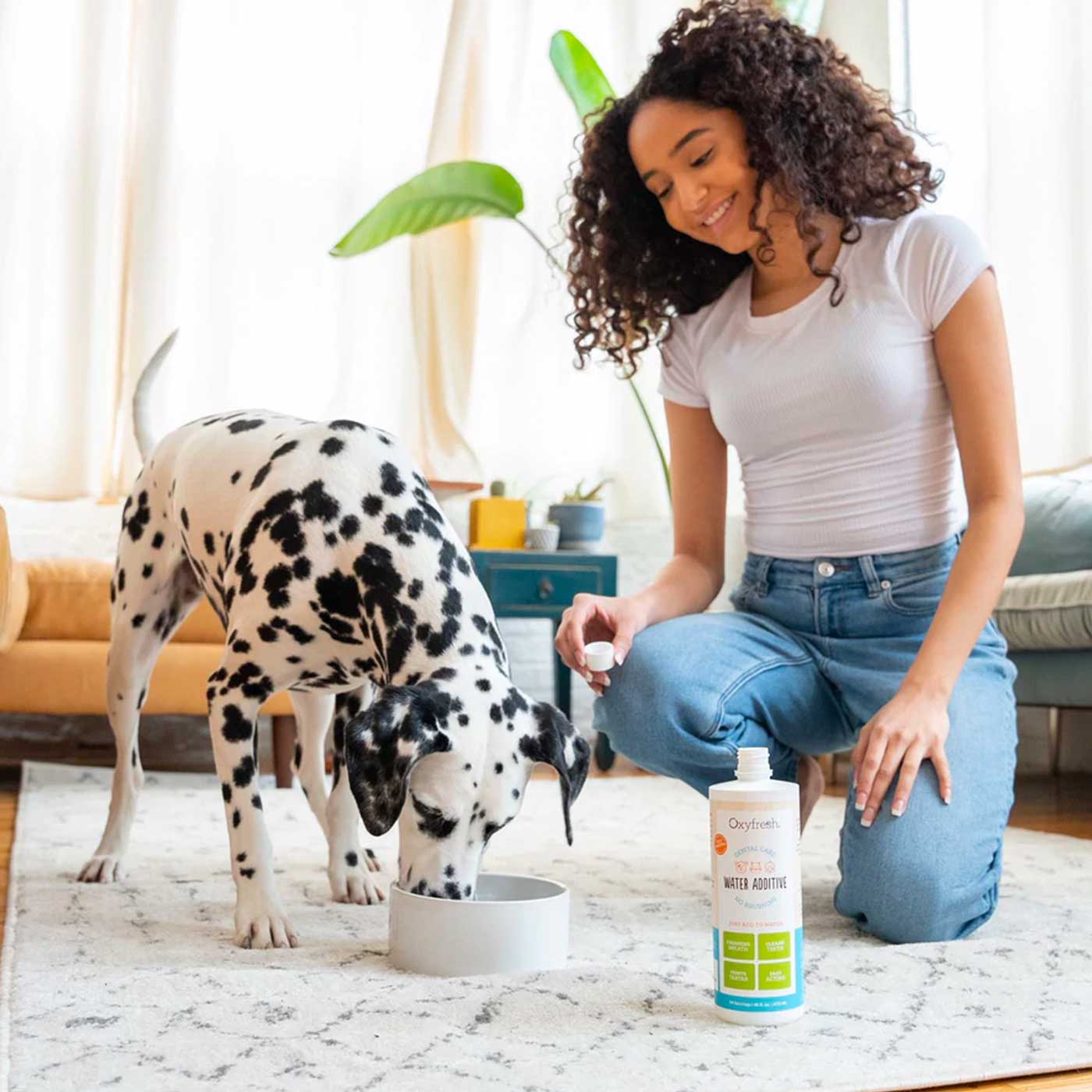 dalmation drinking out of water bowl with oxyfresh pet water additive for fresh breath and good dental health