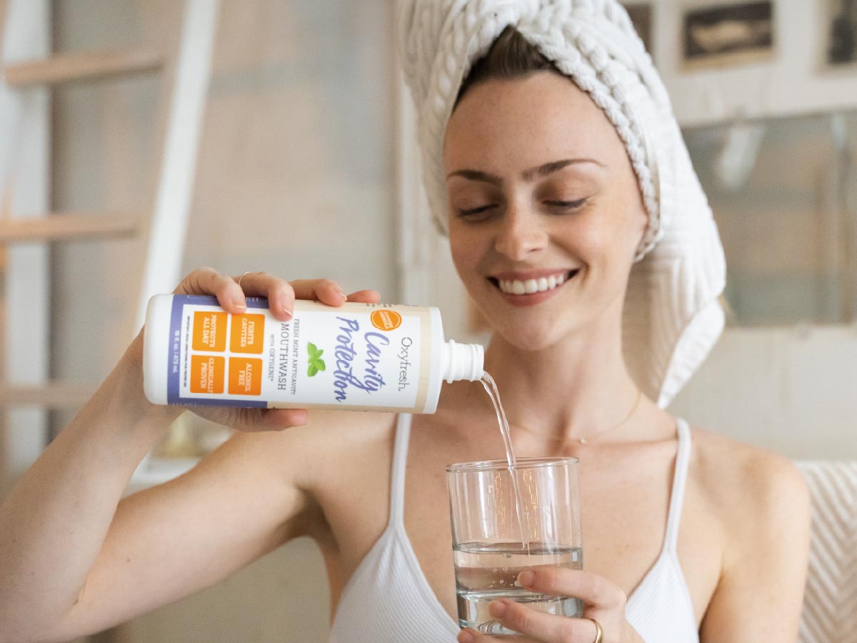 woman-pouring-oxyfresh-best-mouthwash-for-cavities-into-glass