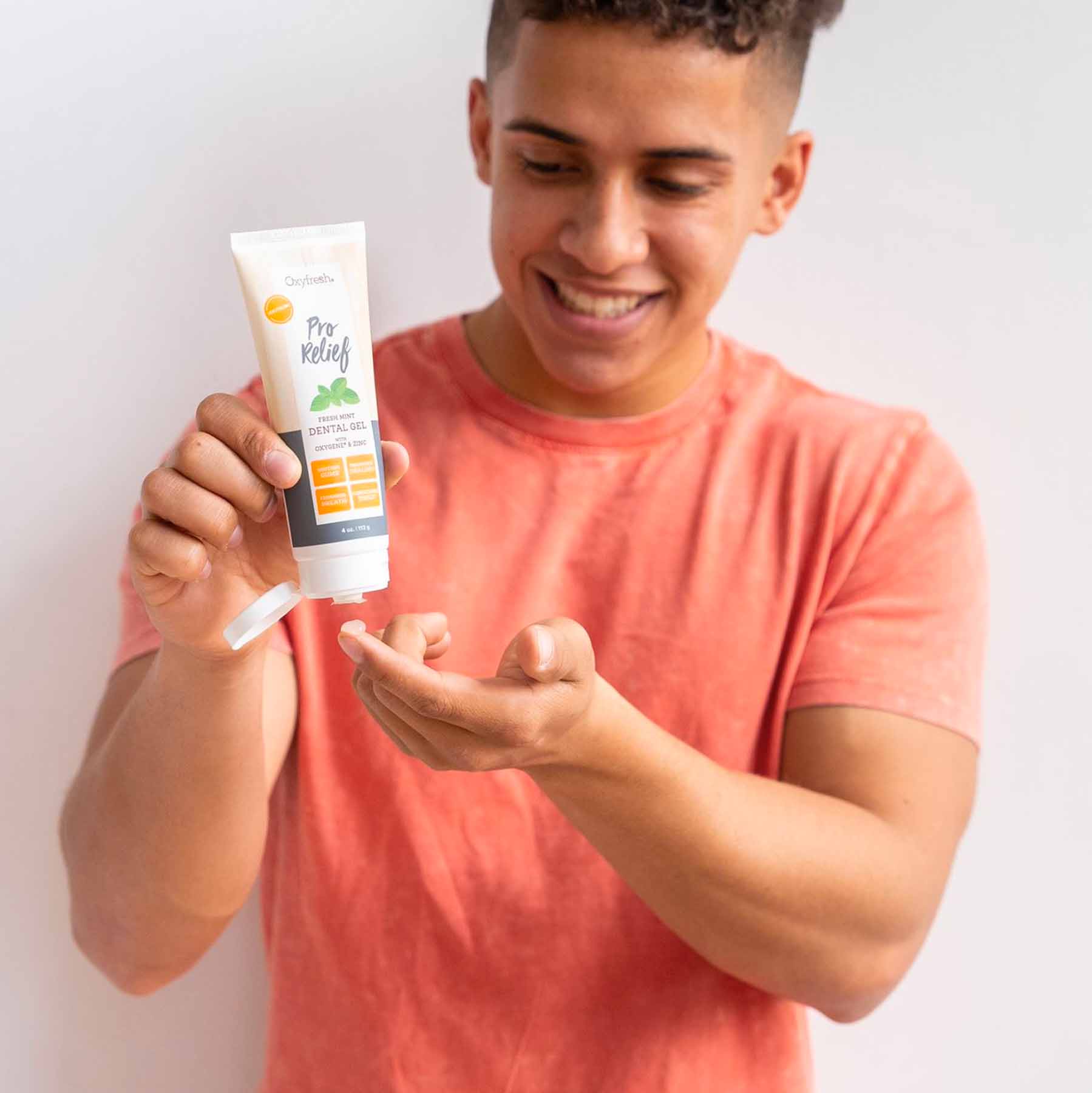 oxyfresh-dental-gel-for-gums-guy-squeezing
