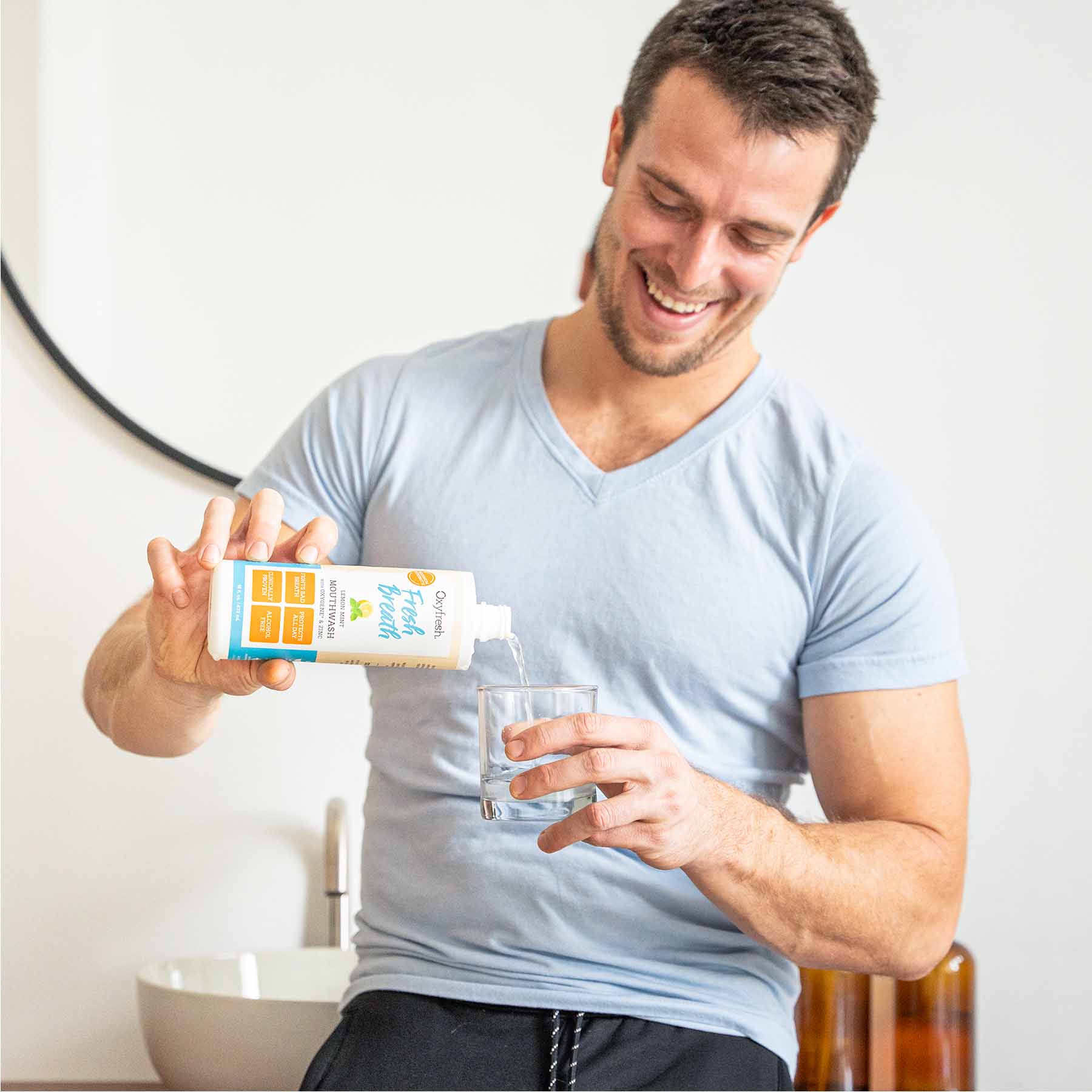 oxyfresh-man-pouring-lemon-mint-mouthwash