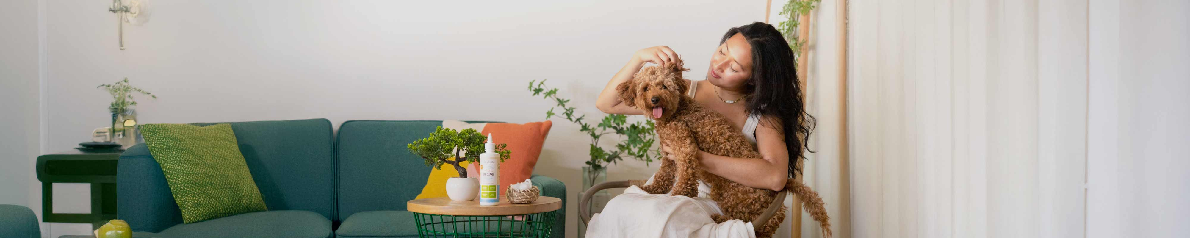 oxyfresh-pet-ear-cleaner-helps-with-stinky-gunky-pet-ears-woman-peering-into-her-golden-doodles-ear-to-check-how-clean-and-fresh-it-is-after-using-this-premium-ear-wash