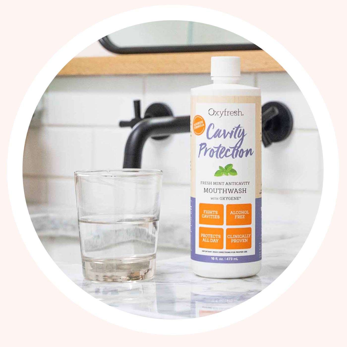 oxyfresh-cavity-protection-fluoride-mouthwash-for-sensitive-teeth-on-counter-next-to-glass