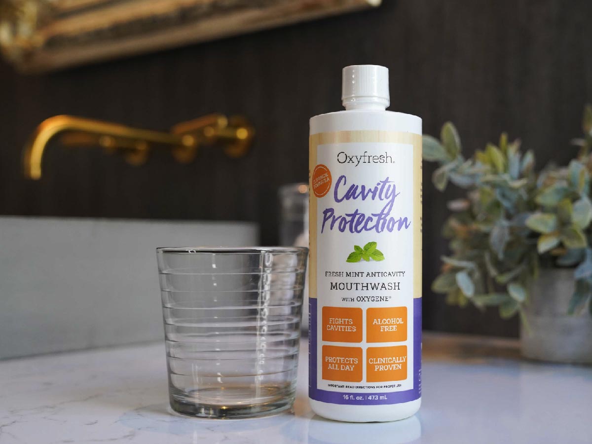 oxyfresh-remineralizing-mouthwash-for-sensitive-teeth-on-counter-next-to-glass